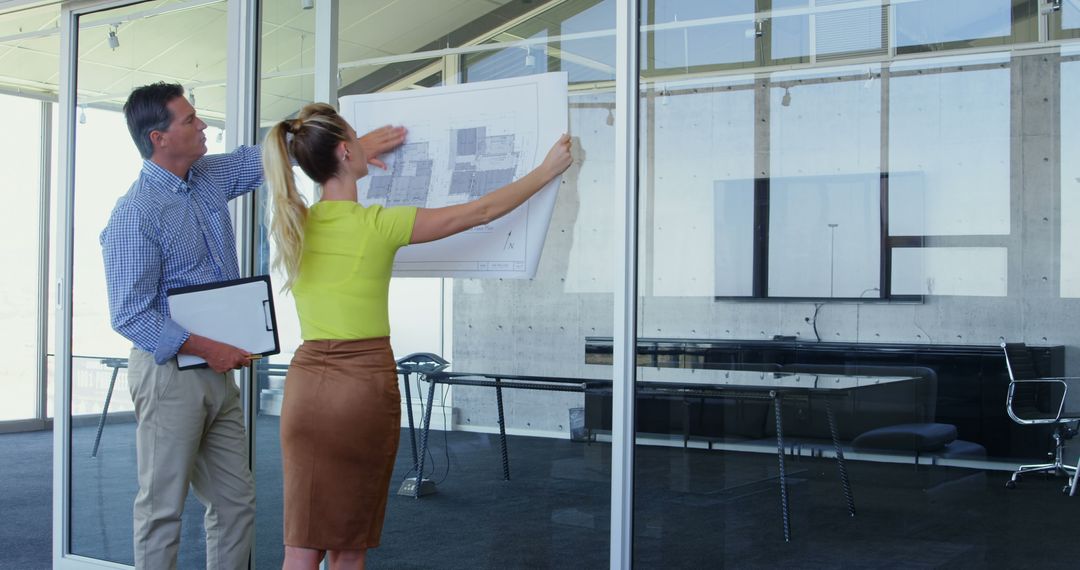 Architect Team Analyzing Design Blueprint in Modern Office