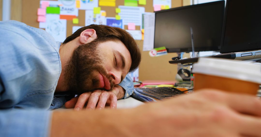 Exhausted Man Sleeping at Desk in Busy Office - Free Images, Stock Photos and Pictures on Pikwizard.com