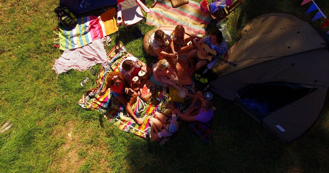 Group of Friends Enjoying Picnic on Colorful Blankets in Sunlit Park - Free Images, Stock Photos and Pictures on Pikwizard.com