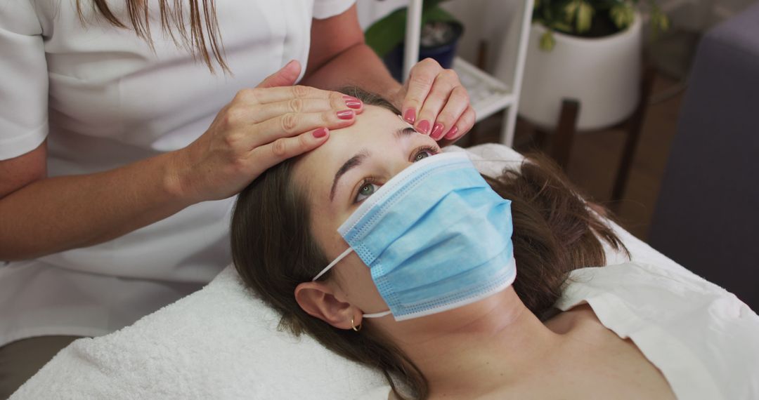 Esthetician Performing Facial Massage on Woman with Face Mask - Free Images, Stock Photos and Pictures on Pikwizard.com