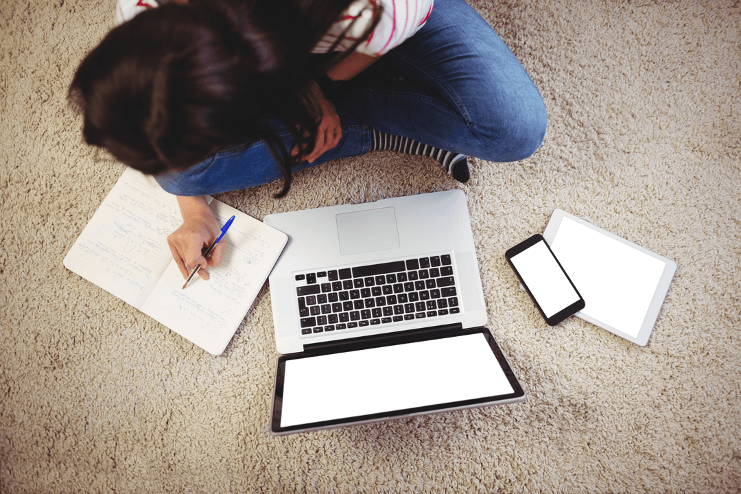 Woman Sitting on Rug with Laptop and Tablets Concept