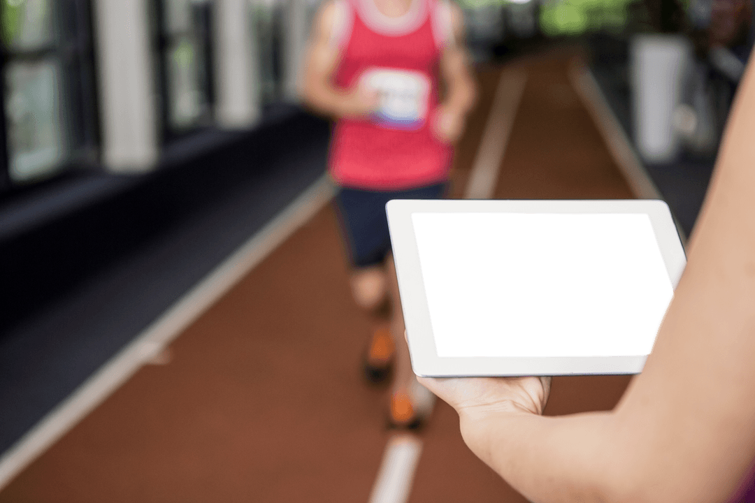 Holding Transparent Tablet with Athlete Running in Background