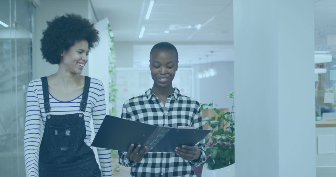 Diverse Professionally Dressed Colleagues Discussing Work Documents