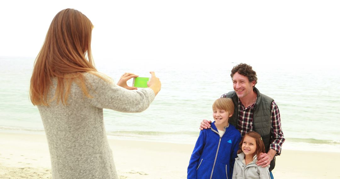 Mother Photographing Family on Beach during Vacation - Free Images, Stock Photos and Pictures on Pikwizard.com