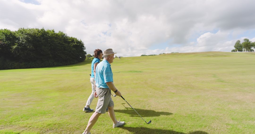 Senior Couple Enjoying Leisurely Walk on Golf Course