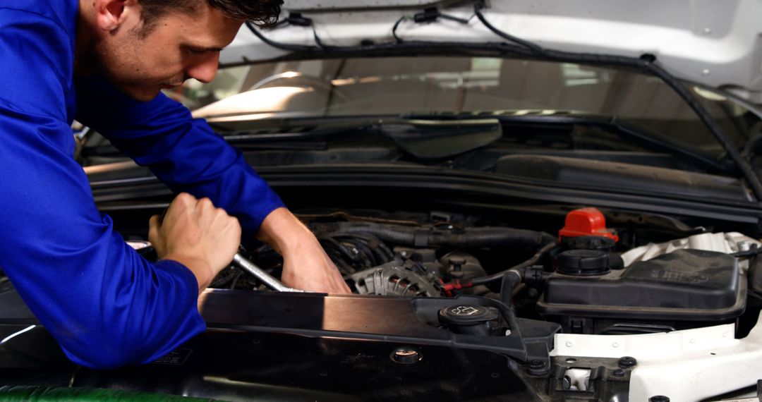 Auto Mechanic Fixing Car Engine in Workshop - Free Images, Stock Photos and Pictures on Pikwizard.com