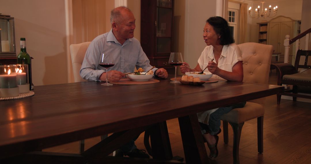 Senior Couple Enjoying Dinner and Wine in Cozy Home Setting
