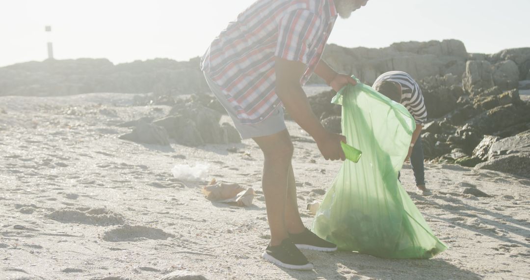 People Cleaning Beach Collecting Trash Outdoors - Free Images, Stock Photos and Pictures on Pikwizard.com