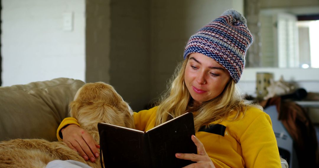 Woman Relaxing with Dog and Reading Book on Sofa in Cozy Home - Free Images, Stock Photos and Pictures on Pikwizard.com