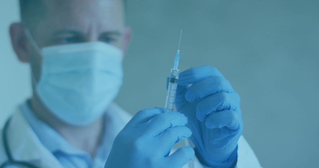 Doctor in Mask Holding Vaccine Syringe With Focus
