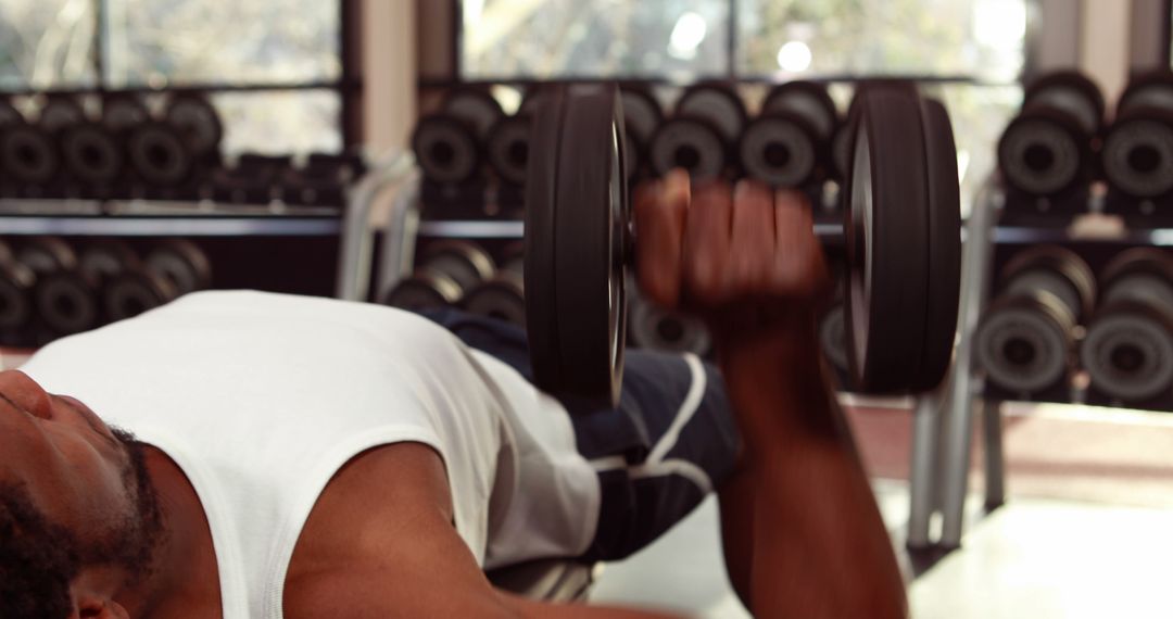 Focused Athletic African American Man Lifting Dumbbell in Gym - Free Images, Stock Photos and Pictures on Pikwizard.com