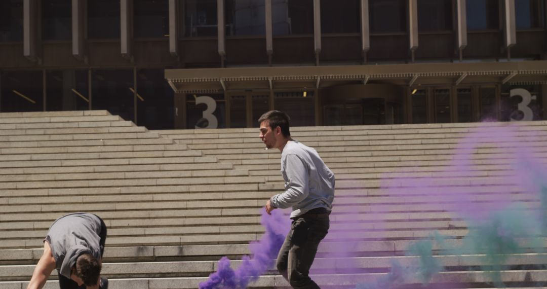 Young people enjoying colorful smoke bombs on concrete steps - Free Images, Stock Photos and Pictures on Pikwizard.com