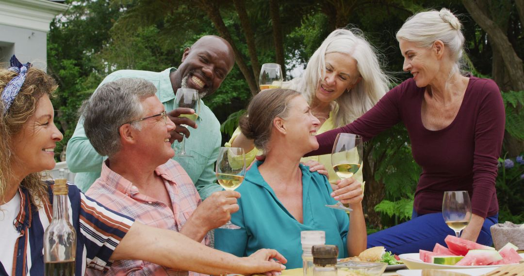 Image of diverse happy senior female and male friends eating lunch in garden - Free Images, Stock Photos and Pictures on Pikwizard.com