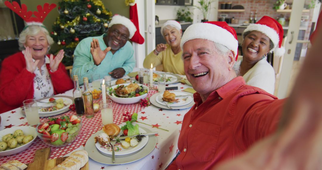 Diverse Senior Group Celebrating Christmas with Festive Meal and Santa Hats - Free Images, Stock Photos and Pictures on Pikwizard.com