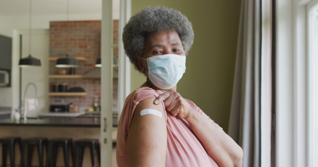 Senior Woman Showing Vaccine Bandage at Home - Free Images, Stock Photos and Pictures on Pikwizard.com