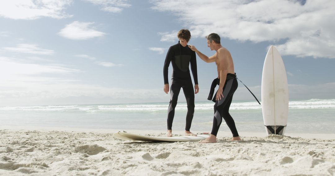 Surf Instructor Teaching Teenager on Beach - Free Images, Stock Photos and Pictures on Pikwizard.com