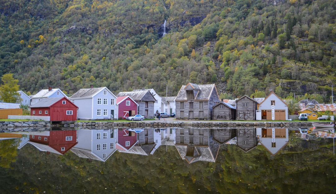 Charming Nordic Village Houses Reflecting on Tranquil Lake - Free Images, Stock Photos and Pictures on Pikwizard.com
