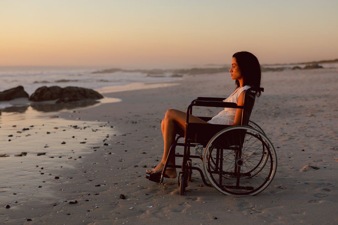 Disabled woman in wheelchair on the beach - Free Images, Stock Photos and Pictures on Pikwizard.com