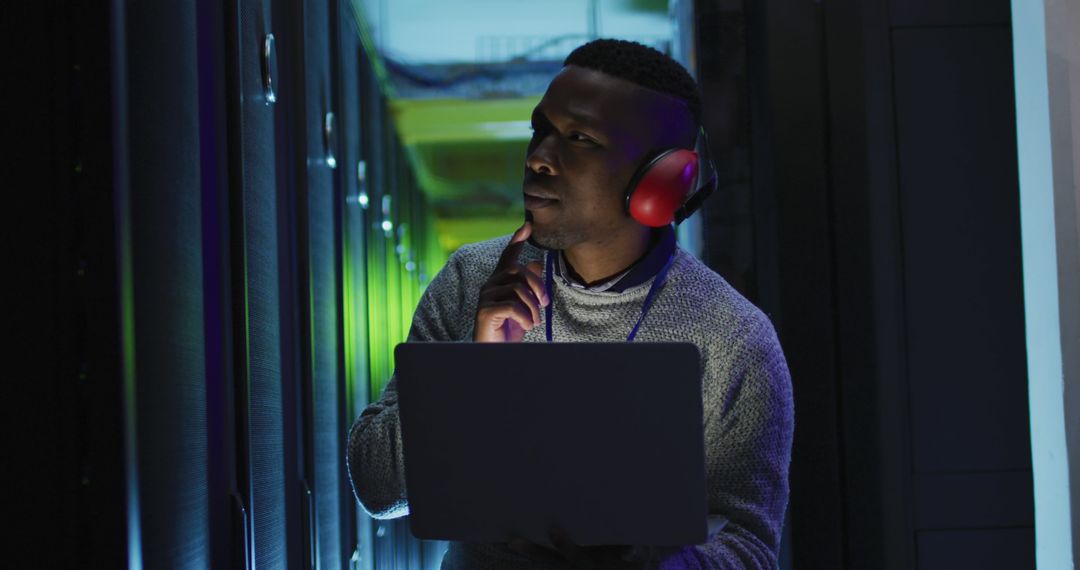 IT Technician Analyzing Server Room with Laptop - Free Images, Stock Photos and Pictures on Pikwizard.com