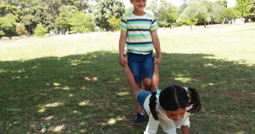 Children Playing Wheelbarrow Race Game in Park - Free Images, Stock Photos and Pictures on Pikwizard.com