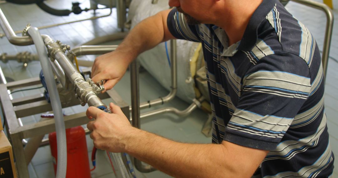 Male Worker Adjusting Industrial Equipment in Factory - Free Images, Stock Photos and Pictures on Pikwizard.com