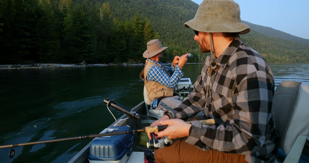 Men Fishing on Tranquil Lake in the Mountains - Free Images, Stock Photos and Pictures on Pikwizard.com