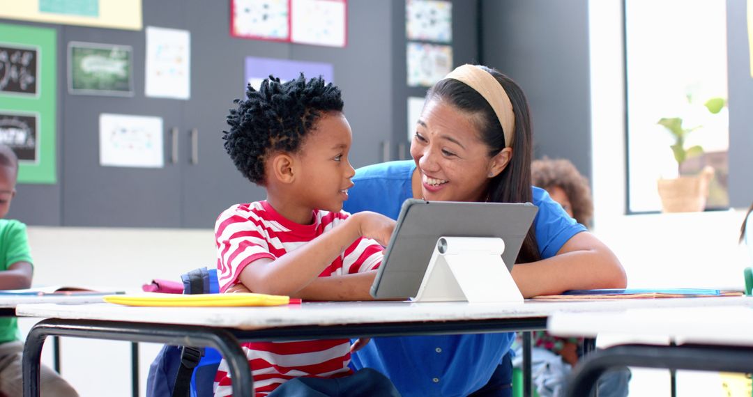 Teacher and Student Using Tablet in Classroom Setting
