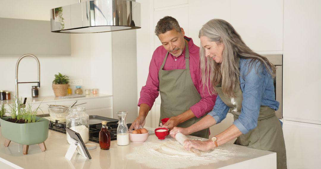Smiling Senior Couple Baking Together in Modern Kitchen