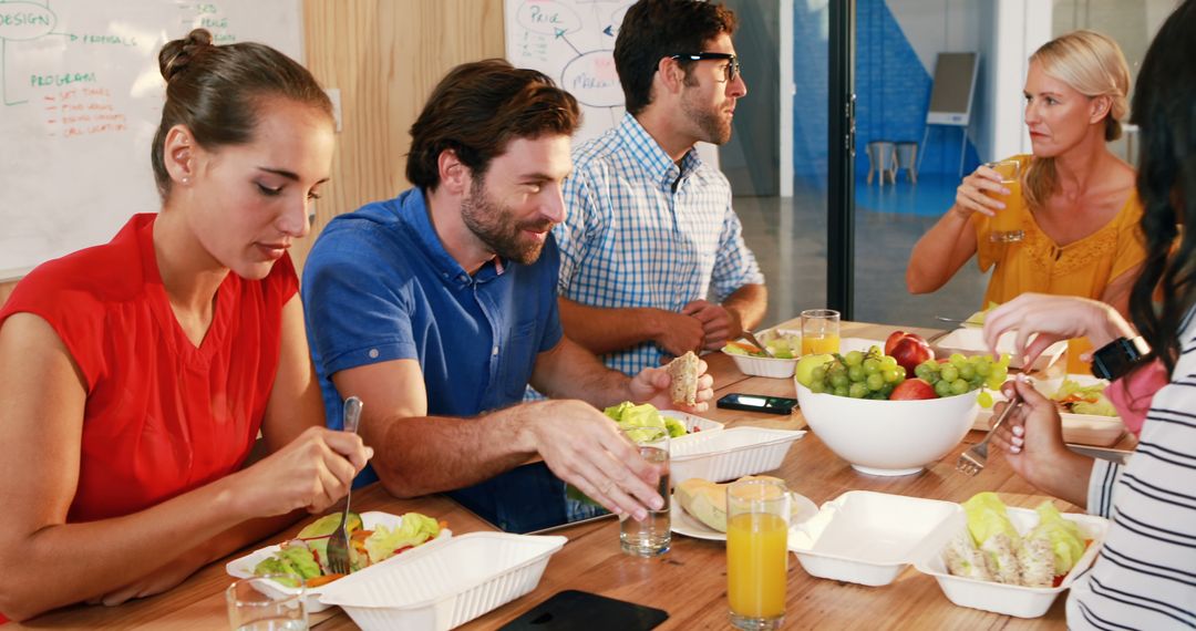 Colleagues Enjoying Healthy Lunch Together in Office - Free Images, Stock Photos and Pictures on Pikwizard.com