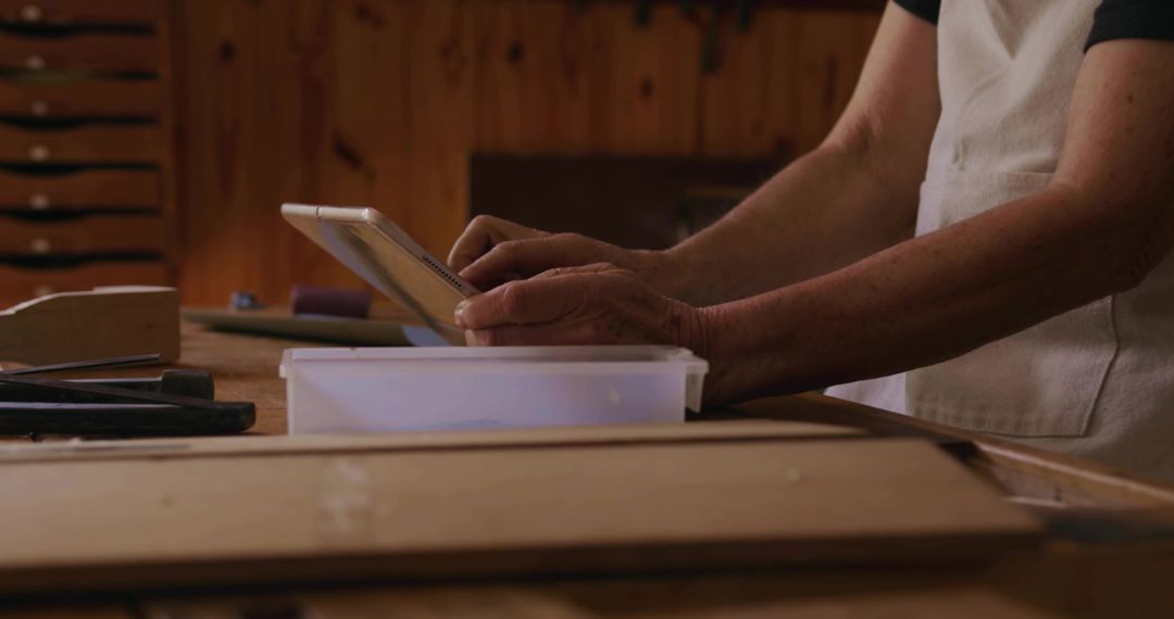 Senior Artisan Consulting Tablet at Woodworking Bench Planning Craftsmanship Project