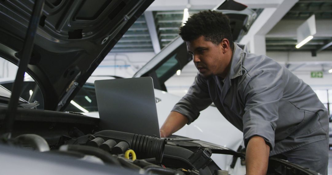 Young Male Mechanic Using Laptop to Diagnose Car Engine - Free Images, Stock Photos and Pictures on Pikwizard.com