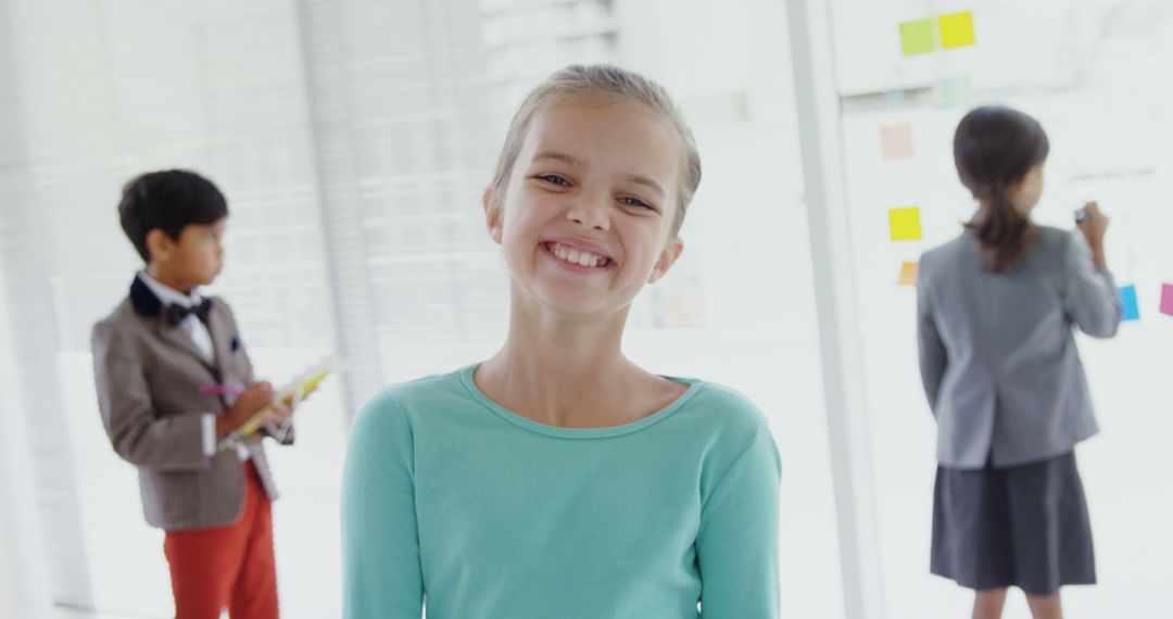 Smiling Child in Classroom with Peers in Background - Free Images, Stock Photos and Pictures on Pikwizard.com