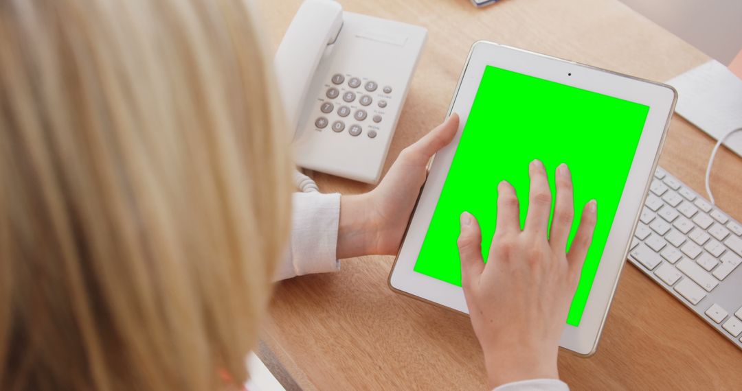 Woman Using Tablet with Green Screen at Desk - Free Images, Stock Photos and Pictures on Pikwizard.com