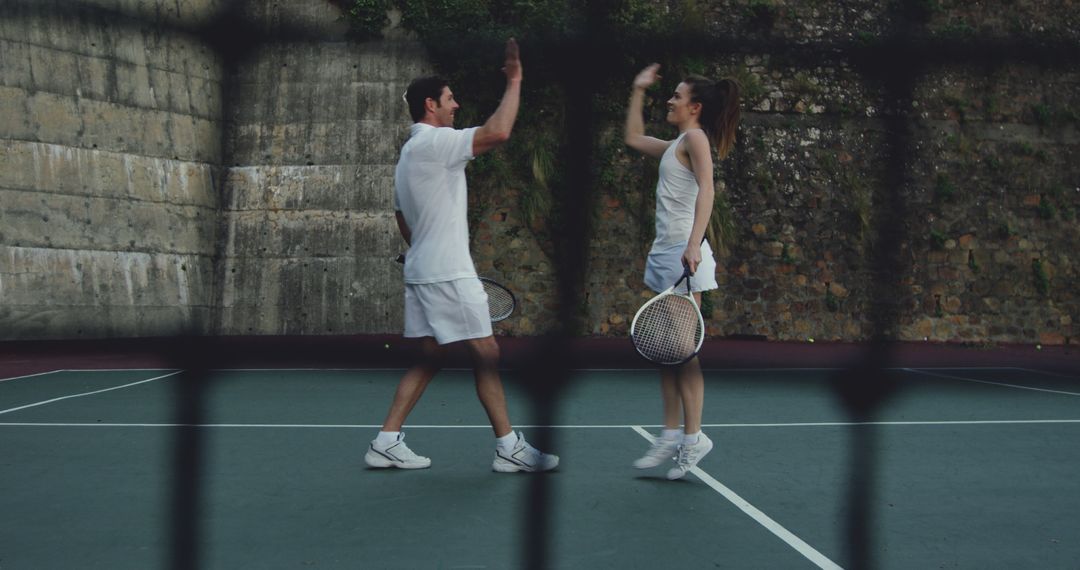 Mixed Doubles Tennis Players Celebrating on Court - Free Images, Stock Photos and Pictures on Pikwizard.com