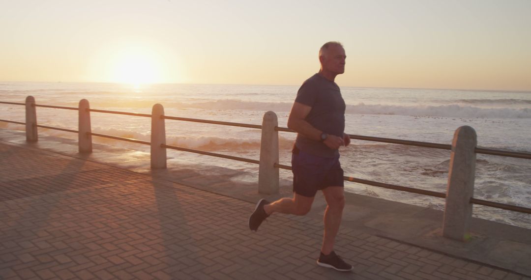 Senior Man Jogging Along Beachfront at Sunrise - Free Images, Stock Photos and Pictures on Pikwizard.com