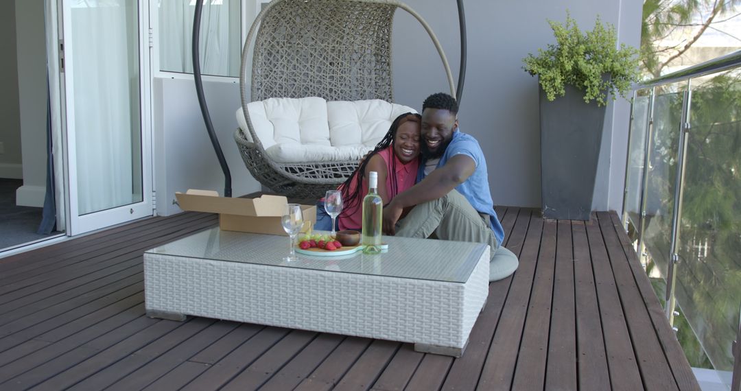 Couple Enjoying Pizza and Relaxation on Modern Balcony