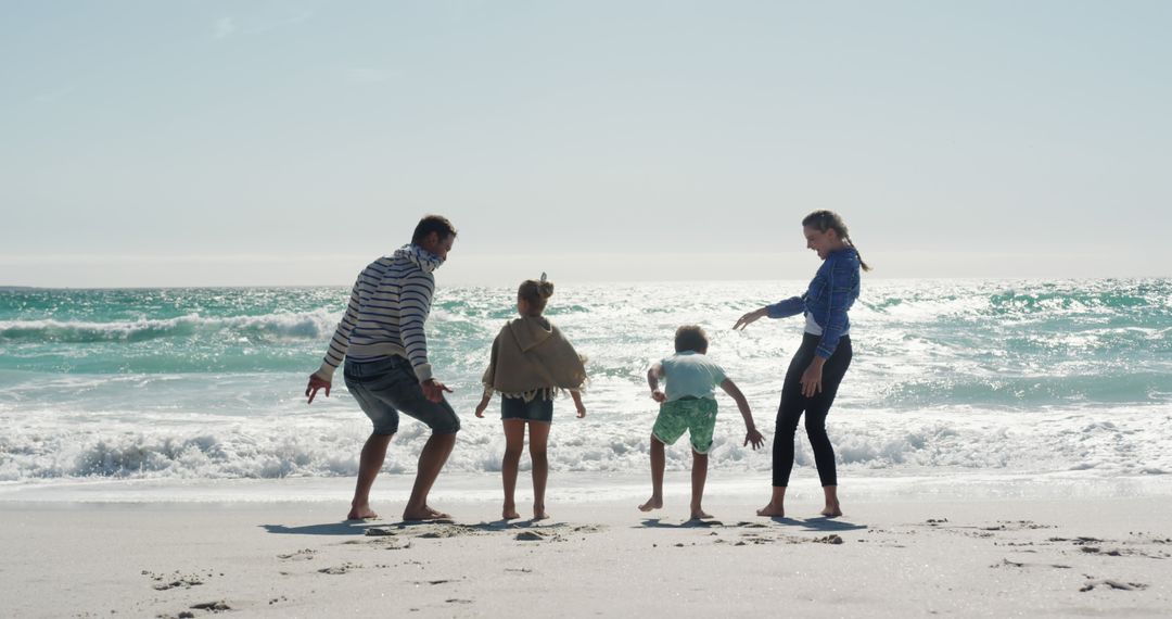 Happy Family Playing on the Beach Against Ocean Waves - Free Images, Stock Photos and Pictures on Pikwizard.com