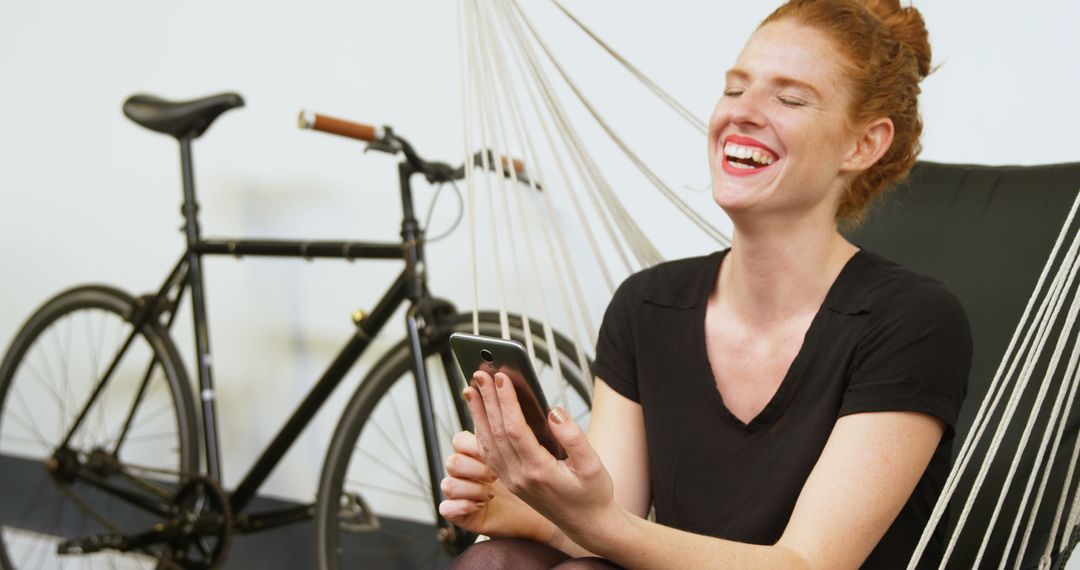 Smiling Woman Relaxing in Hammock Chair with Smartphone - Free Images, Stock Photos and Pictures on Pikwizard.com