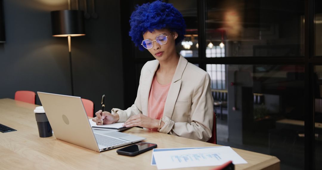 Businesswoman with Blue Hair Working on Laptop in Modern Office - Free Images, Stock Photos and Pictures on Pikwizard.com