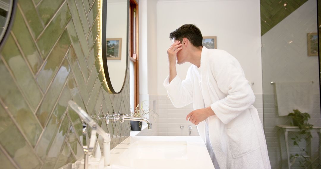 Man Inspecting Hair and Face in Bathroom Mirror for Grooming Routine
