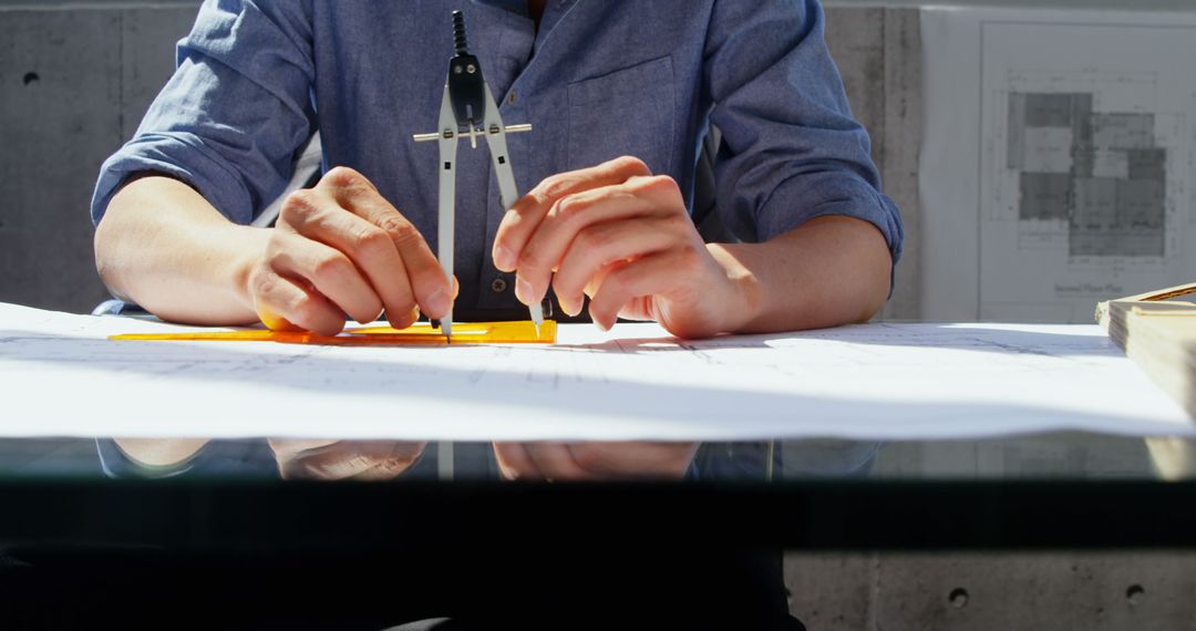 Architect Planning Blueprint with Compass in Modern Office