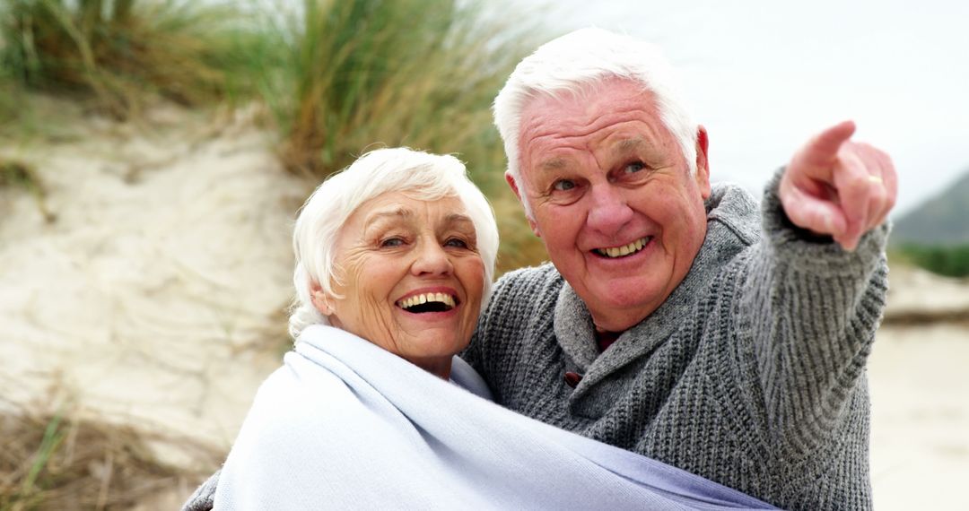 An elderly couple enjoys a tender moment on the beach, reminiscing and looking ahead. - Free Images, Stock Photos and Pictures on Pikwizard.com