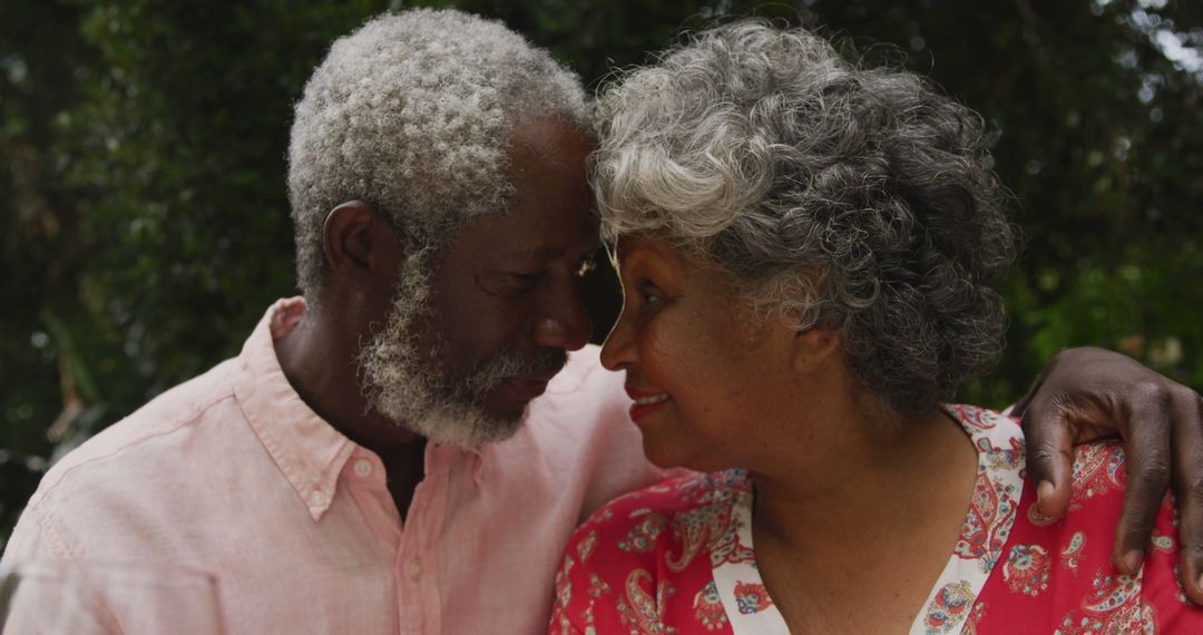 Senior biracial couple shares a tender moment outdoors - Free Images, Stock Photos and Pictures on Pikwizard.com
