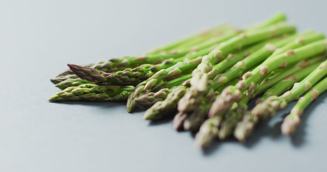 Image of close up of fresh asparagus over grey background - Free Images, Stock Photos and Pictures on Pikwizard.com