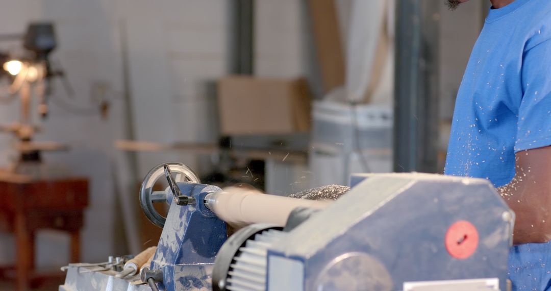 Carpenter Using Lathe to Shape Wood in Workshop