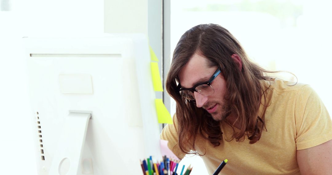 Long-haired Man Working at Computer in Modern Office - Free Images, Stock Photos and Pictures on Pikwizard.com