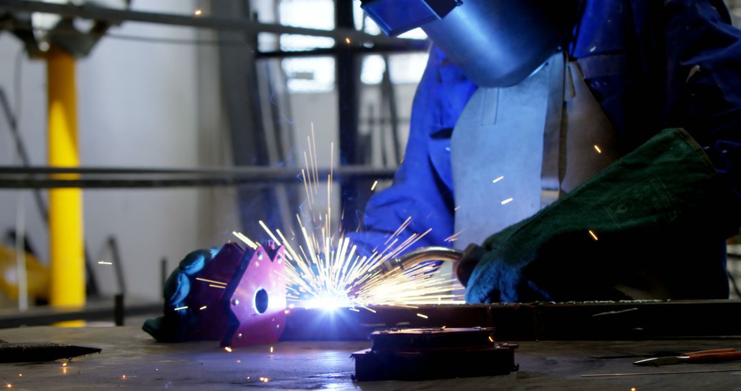 Industrial Worker Welding Metal in Factory, Creating Sparks - Free Images, Stock Photos and Pictures on Pikwizard.com