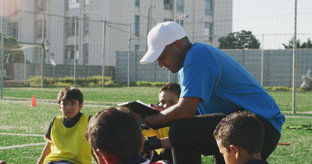 Soccer Coach Giving Instructions to Youth Team during Practice - Free Images, Stock Photos and Pictures on Pikwizard.com