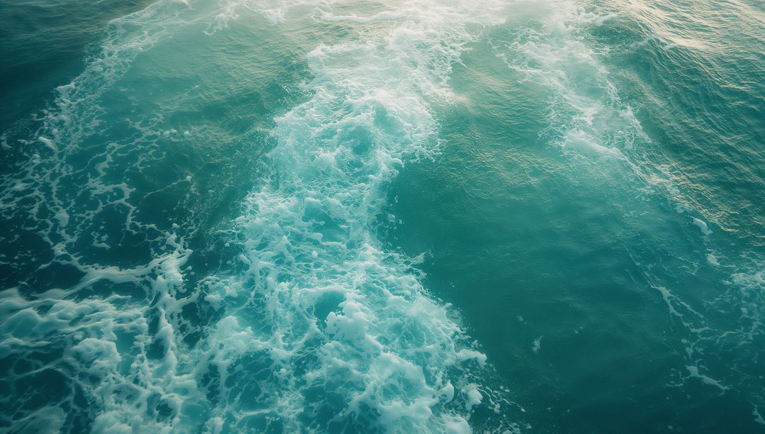 Turquoise Ocean Waves with Swirling White Foam