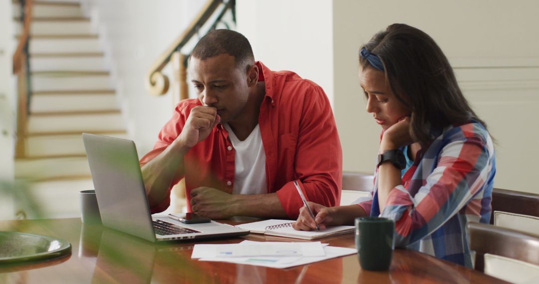 Stressed Couple Managing Home Budget with Laptop